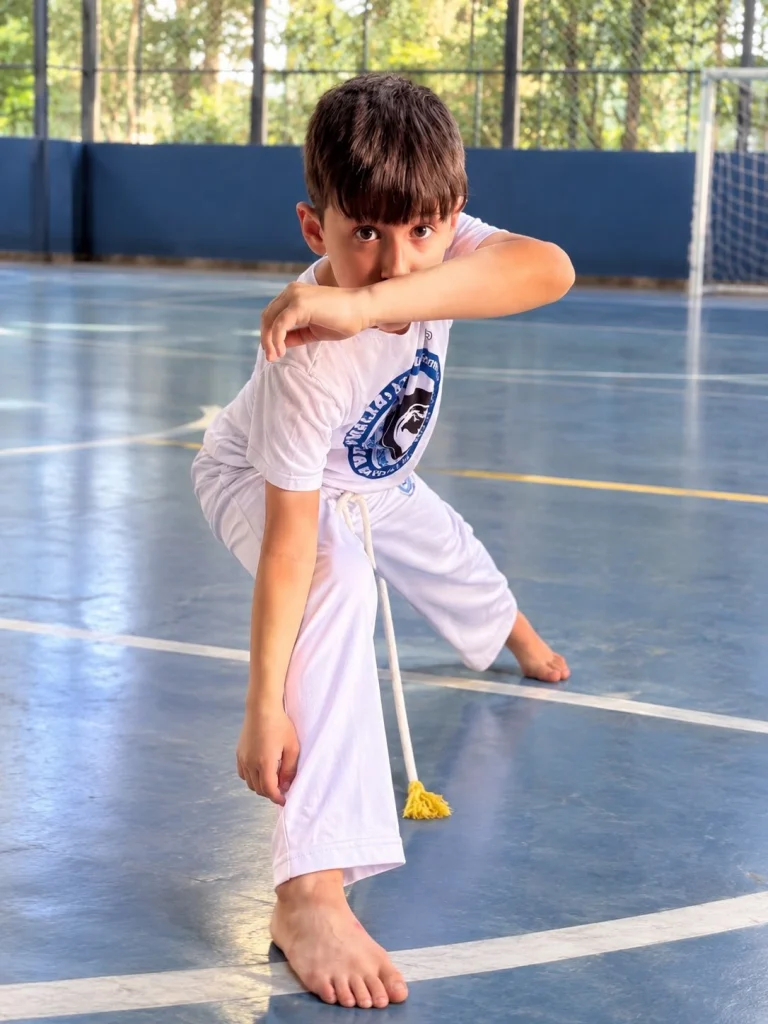 Aluno na aula de capoeira na quadra